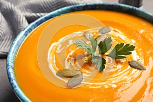 Bowl with tasty pumpkin soup on table