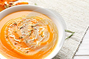 Bowl with tasty pumpkin soup on table