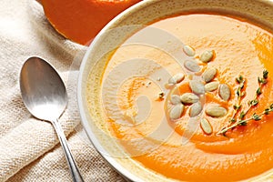 Bowl with tasty pumpkin soup on table