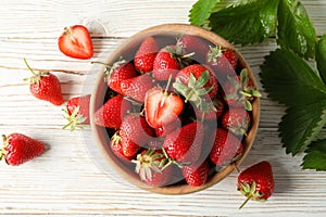 Bowl with tasty strawberry on wooden table Summer berry