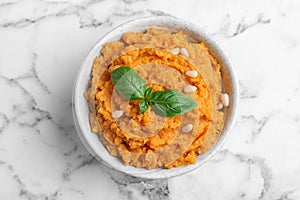 Bowl of tasty sweet potato puree on marble table