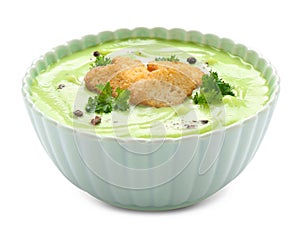 Bowl with tasty zucchini soup on white background