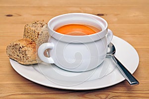 Bowl of tomatoe soup with brown bread