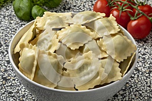 Bowl with traditional fresh Italian raviolini stuffed with Basilicum and Provolone