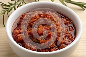 Bowl with traditional homemade dried tomato tapenade close up