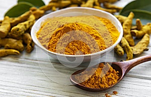 Bowl with turmeric powder and dry roots