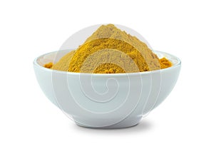 A bowl of turmeric powder isolated from the white background