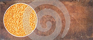 Bowl of uncooked dhal on wooden board
