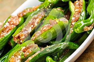 Bowl of Uncooked Fresh Stuffed Green Peppers Ready for Cooking