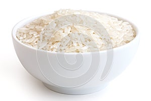 Bowl of uncooked white long grain rice on white