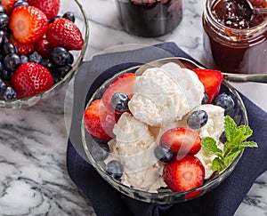 Bowl of Vanilla Ice Cream With Blueberries and Strawberries