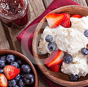 Bowl of Vanilla Ice Cream With Blueberries and Strawberries