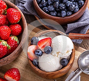 Bowl of Vanilla Ice Cream With Blueberries and Strawberries
