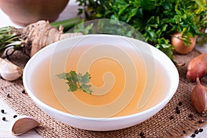 Bowl of vegetable broth. Broth, bouillon, clear soup in a large white bowl close-up