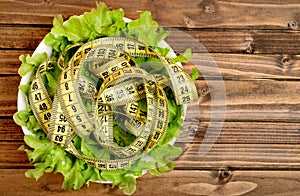 Bowl with vegetable salad and centimeter