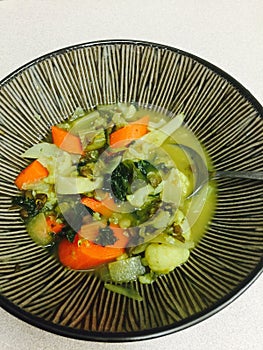 Bowl of vegetable soup with spoon