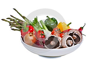 Bowl of vegetables isolated on white.