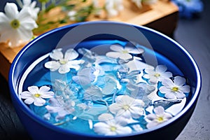bowl of water with floating flowers for hydropathic therapy