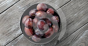 Bowl of wet ripe plums
