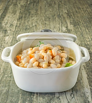 A bowl of white beans and carrot stew