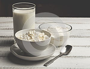 Bowl of white cream, curd and homemade milk on white wooden rustic background, Healthy dairy farm food