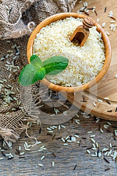 Bowl of white long grain rice on the old sacking.