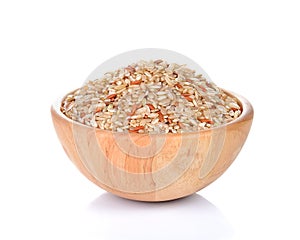 Bowl of whole brown rice isolated on white background