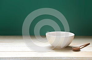 Bowl on wooden empty space table and green background.Food backdrop