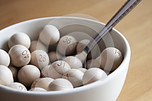 Bowl of Wooden Lottery Balls with Spoon photo