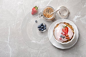 Bowl with yogurt, berries and granola on table