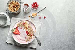 Bowl with yogurt, berries and granola on table