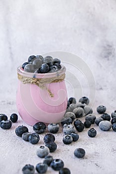 Bowl with yogurt and blueberries on table. Blueberry yogurt with fresh blueberries. Healthy breakfast. Super food