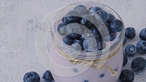 Bowl with yogurt and blueberries on table. Blueberry yogurt with fresh blueberries. Healthy breakfast. Super food