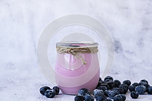 Bowl with yogurt and blueberries on table. Blueberry yogurt with fresh blueberries. Healthy breakfast. Super food