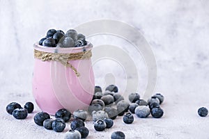 Bowl with yogurt and blueberries on table. Blueberry yogurt with fresh blueberries. Healthy breakfast. Super food