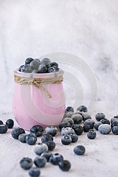 Bowl with yogurt and blueberries on table. Blueberry yogurt with fresh blueberries. Healthy breakfast. Super food