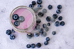 Bowl with yogurt and blueberries on table. Blueberry yogurt with fresh blueberries. Healthy breakfast. Super food