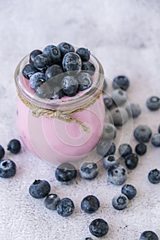 Bowl with yogurt and blueberries on table. Blueberry yogurt with fresh blueberries. Healthy breakfast. Super food