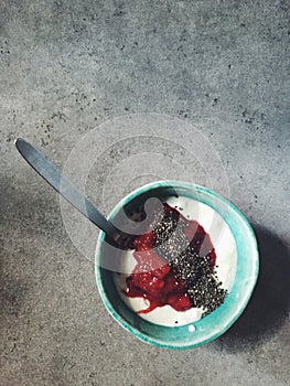 Bowl of yogurt with rhubard-red currant compote and chia seeds