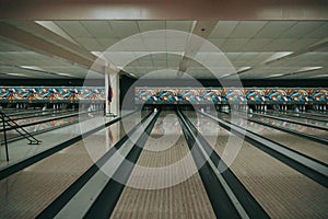 Bowling alley featuring lines to the right of the lane, decorated with graffiti
