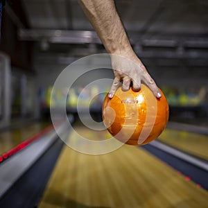 Bowling ball at hand man background bowling alley