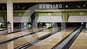 Bowling ball knocking pins on the bowling lane. Bowling strike in slow motion. Concept of success and win.