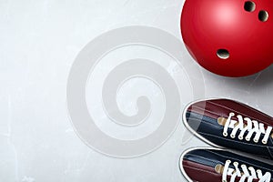 Bowling ball and shoes on light grey marble background, flat lay. Space for text