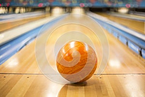 Bowling ball sitting in a colorful bowling alley lane