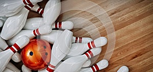 Bowling balls and bowling pins placed on a wooden background