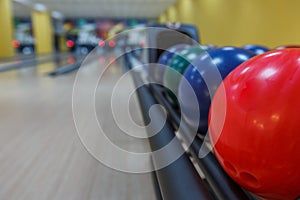 Bowling balls return machine, alley background