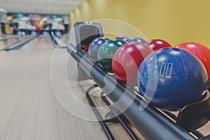 Bowling balls return machine, alley background