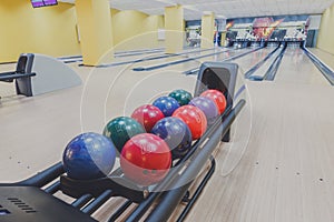 Bowling balls return machine, alley background