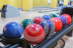 Bowling balls return machine, alley background