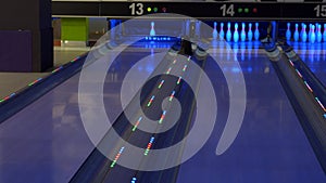 Bowling game. A bowling ball traveling down the lane and knocks down pins